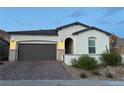 Charming single-story home featuring desert landscaping, a brick driveway, and a two-car garage at 80 Cathedral Wash Pl, Henderson, NV 89011