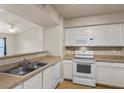 Kitchen with white appliances, view to living area at 8000 Badura Ave # 2028, Las Vegas, NV 89113