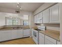 Cozy kitchen featuring white cabinets and appliances at 8000 Badura Ave # 2028, Las Vegas, NV 89113