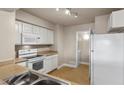 Kitchen with white appliances and view to laundry area at 8000 Badura Ave # 2028, Las Vegas, NV 89113