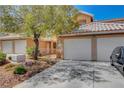 Inviting two-story home with a two-car garage, low-maintenance yard, and driveway parking at 8048 Astrology Ct # 201, Las Vegas, NV 89128