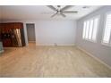 Spacious living area with tile floors, a ceiling fan, and view into kitchen at 8084 Bosco Bay Ave, Las Vegas, NV 89113