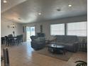 Open concept living room with tile floor, recessed lighting, and large window, next to the dining area at 901 Rockaway St, Las Vegas, NV 89145