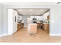 Open kitchen boasts white upper cabinets, wood lower cabinets, and a center island at 915 Melrose Dr, Las Vegas, NV 89101