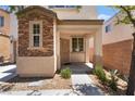 Charming home featuring a porch with columns and a well-maintained front yard at 10164 Village Breeze Pl, Las Vegas, NV 89183