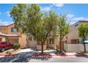 Charming two-story home featuring a garage, a well-maintained front yard and a sidewalk at 10164 Village Breeze Pl, Las Vegas, NV 89183