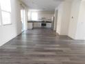 Open-concept living area with modern flooring leading into the kitchen at 11173 Hickory Glen St, Las Vegas, NV 89179