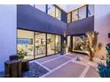 Contemporary courtyard with desert landscaping and water feature leading to the home's entrance at 12 Desert Lake Ln, Henderson, NV 89011