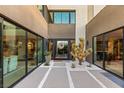 Contemporary home entrance with desert landscaping, a decorative wreath on the front door, and modern exterior finishes at 12 Desert Lake Ln, Henderson, NV 89011