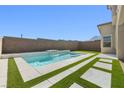 Backyard view featuring a sleek pool with integrated water features and contemporary landscaping for a modern aesthetic at 12039 Rockview Point St, Las Vegas, NV 89138