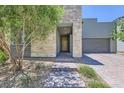 Inviting entryway featuring stone accents, a covered porch, and a well-maintained, drought-resistant landscape at 1213 Granite Falls Pl, North Las Vegas, NV 89084