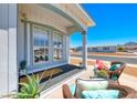 Charming front porch with wicker furniture, plants, and a welcoming ambiance at 1290 Dalene Ave, Henderson, NV 89002