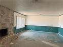 Spacious living room featuring a cozy fireplace and ample natural light at 1590 Raindance Way, Las Vegas, NV 89169