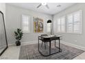 Bright office space features plantation shutters, a modern desk, and neutral decor, ideal for a productive work environment at 18 Via Tiberina, Henderson, NV 89011
