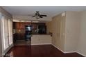 An open-concept living area featuring wood floors and a kitchen visible in the background at 1851 Hillpointe Rd # 1711, Henderson, NV 89074