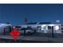 Exterior view of a cozy home with a car parked outside at twilight at 2217 Santa Ynez Dr, Las Vegas, NV 89104