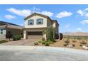 Two-story home featuring a desert landscape, brown garage door and blue shutters at 2343 Teatro Ave, Henderson, NV 89044