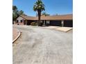 Home featuring a large driveway, mature trees, and a spacious two car garage at 2645 Lindell Rd, Las Vegas, NV 89146