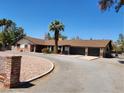 Spacious property boasts an oversized driveway leading to an attached garage and mature palm trees at 2645 Lindell Rd, Las Vegas, NV 89146