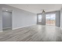 Spacious living room with grey wood-look floors and balcony access at 27 E Agate Ave # 505, Las Vegas, NV 89123