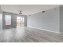 Bright living room with grey walls, white trim and balcony access at 27 E Agate Ave # 505, Las Vegas, NV 89123