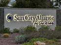 Illuminated Sun City Aliante by Del Webb community sign surrounded by lush landscaping at 2704 Willow Wren Dr, North Las Vegas, NV 89084