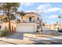 Two-story home featuring a balcony, two car garage, xeriscaped front yard, and a red tile roof at 2789 Trotwood Ln, Las Vegas, NV 89108