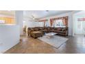 Spacious living room featuring tile flooring, large sofa, and open layout perfect for entertaining at 3029 Brownbirds Nest Dr, Henderson, NV 89052