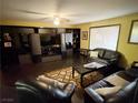 Inviting living room showcasing custom built-ins, a ceiling fan, and sleek, dark furnishings at 3167 El Cedro Cir, Las Vegas, NV 89121