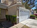 Charming home featuring a two-car garage, decorative stone accents, and trimmed landscaping at 3606 Gold Sluice Ave, North Las Vegas, NV 89032