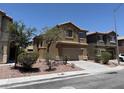 Attractive two-story home with a two-car garage, desert landscaping and tan stucco exterior at 3736 Gallowtree Ave, North Las Vegas, NV 89081