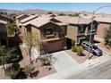 Two-story home featuring a neutral color palette, a tile roof, a two-car garage, and mature landscaping at 3736 Gallowtree Ave, North Las Vegas, NV 89081