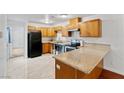 Bright kitchen features wood cabinets, granite counters, and black appliances at 3769 Fairlawn Ave, Las Vegas, NV 89121