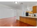 Open floor plan view of living room and kitchen, featuring wood floors at 3769 Fairlawn Ave, Las Vegas, NV 89121