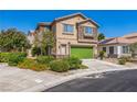 Charming two-story home featuring stone accents, a green garage door, and well-manicured landscaping at 4415 Peaceful Harbor St, Las Vegas, NV 89129