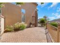 Paver side yard featuring decorative stone and an outdoor seating area and well maintained plants at 4415 Peaceful Harbor St, Las Vegas, NV 89129