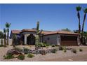 Inviting Southwest home featuring desert landscaping, a Spanish-tile roof, and an attached two-car garage at 444 Viewmont Dr, Henderson, NV 89015