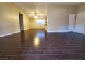 Bright, open living room with dark wood-look floors and a neutral color palette at 4509 Bingham Ave, Las Vegas, NV 89110