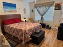 Comfortable bedroom with a queen-sized bed, warm colors, and a window with a view at 5196 Mandalay Springs Dr # 101, Las Vegas, NV 89120