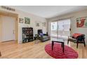 Bright living room with wood floors, a sliding glass door, and neutral walls at 5196 Mandalay Springs Dr # 101, Las Vegas, NV 89120