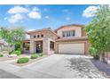 Attractive two-story home featuring a stone facade, desert landscaping and a spacious two-car garage at 5542 Oak Bend Dr, Las Vegas, NV 89135