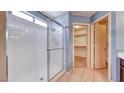 Bathroom showcasing a white tiled shower and a view into the walk-in closet at 6058 Grape Blossom Ave, Las Vegas, NV 89142