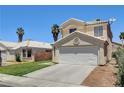 Inviting two-story house with a two car garage, a long driveway, palm trees and desert landscaping at 6058 Grape Blossom Ave, Las Vegas, NV 89142
