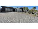 Long, paved driveway leading to a modern single-story home with desert landscaping at 6075 Dapple Gray Rd, Las Vegas, NV 89149