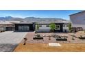 Charming single-story home featuring desert landscaping, a paved driveway, and mountain views at 6075 Dapple Gray Rd, Las Vegas, NV 89149