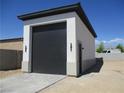 Single car garage with simple, modern design elements and an adjacent access door at 6075 Dapple Gray Rd, Las Vegas, NV 89149