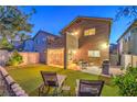 Spacious backyard with an outdoor dining area, BBQ grill, and lounge chairs, offering a perfect retreat at 6546 American Flower St, Las Vegas, NV 89148