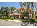 Elegant two-story home featuring a porte-cochere, balcony, and manicured landscaping at 7 Rue Promenade Way, Henderson, NV 89011