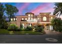 Elegant two-story home with arched windows and a porte-cochere at 7 Rue Promenade Way, Henderson, NV 89011