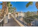 Exterior view showcasing the building's architectural details, pathway, and well-maintained landscape at 7127 S Durango Dr # 310, Las Vegas, NV 89113